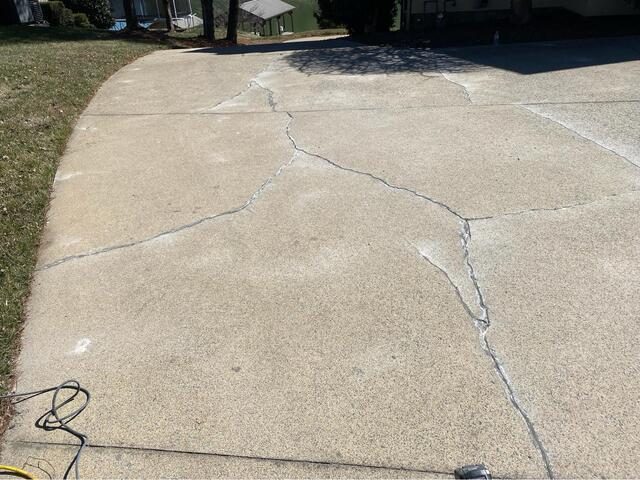 Before photo of large concrete driveway crack